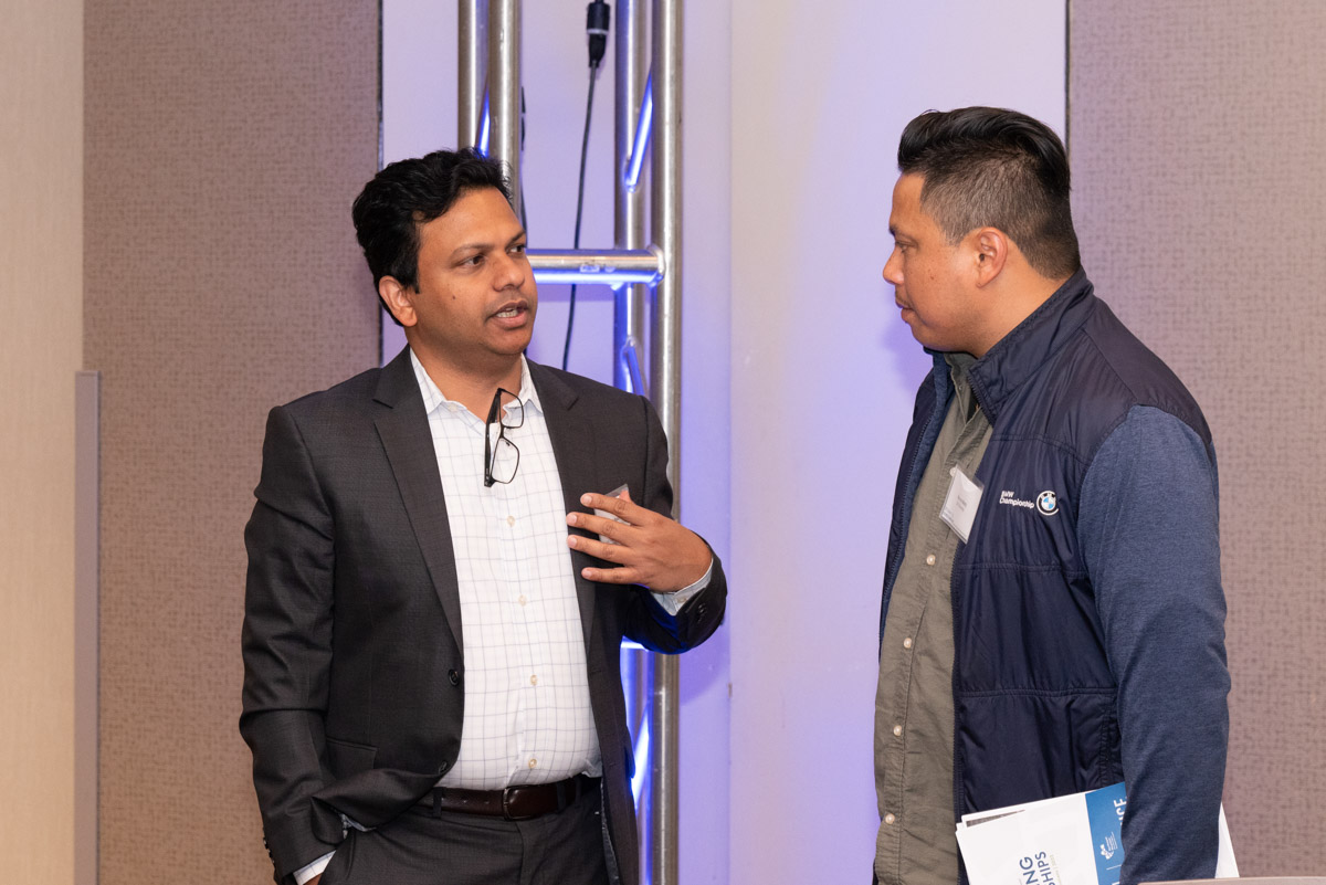 Happy latin architect holding blueprints