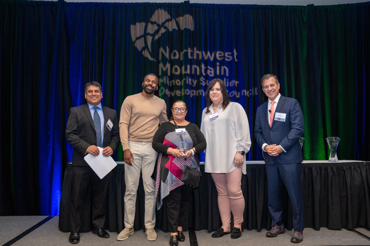 Happy latin architect holding blueprints