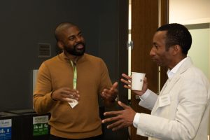 Two people discuss in a conference.