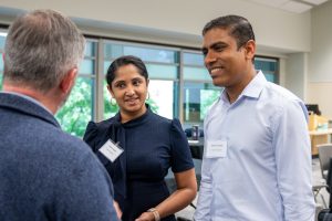 Three diverse business owners network at the business conference.