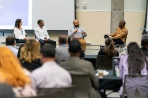 A panel of business owners on stage in front of an audience.